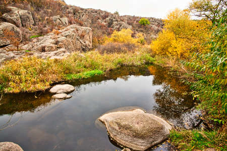 A small wonderful lake along a picturesque river flowing through a beautiful canyon. Huge hatches are in the water. Ukraine.の写真素材