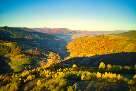 Ukraine. Sunrise shines in the Carpathians, colored fog spreads over the valleys and lowlands of the mountain range, golden prairies are very dazzlingly beautiful.の写真素材