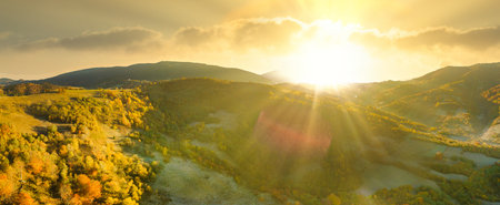 Ukraine. Sunrise shines in the Carpathians, colored fog spreads over the valleys and lowlands of the mountain range, golden prairies are very dazzlingly beautiful.の写真素材