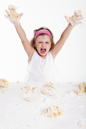 cooking and people concept - girl smiling chef with kitchen utensils, isolated on a white background.の写真素材