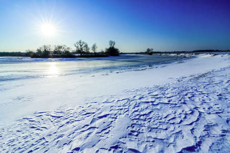 Winter landscape with the river and snow in frosty dayの写真素材