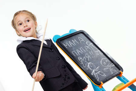 Portrait of a first grader in a school uniform on a white background.の写真素材