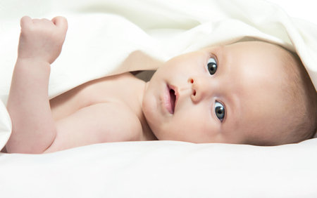 Baby girl After Bath Wrapped in Red Towel Laying and Posingの写真素材
