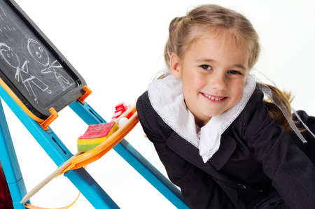 Portrait of a first grader in a school uniform on a white background.の写真素材
