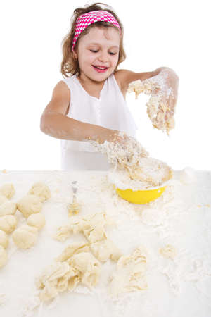 cooking and people concept - girl smiling chef with kitchen utensils, isolated on a white background.の写真素材