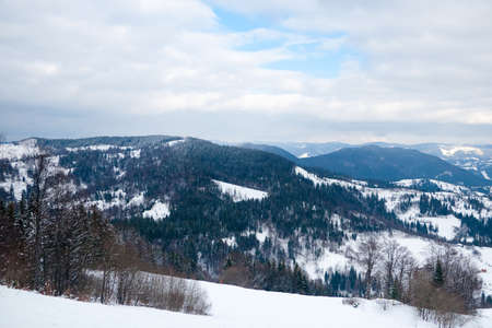 View from the top of mountain on forest in frost and low cloud.の写真素材