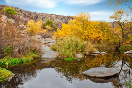 A small wonderful lake along a picturesque river flowing through a beautiful canyon. Huge hatches are in the water. Ukraine.の写真素材