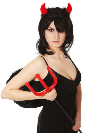 A beautiful, sexy woman in a devil costume, a demon with horns and pitchforks, a trident, in a red dress. American, dress for a costume party Halloween. Choker on the neck. Bright makeupの写真素材