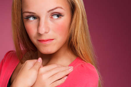 Fashion portrait of elegant young woman with  blonde hair over pink backgroundの写真素材
