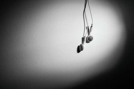 White Minimalist Wired Earphone at gray Background, for Music or Audio Design Element.