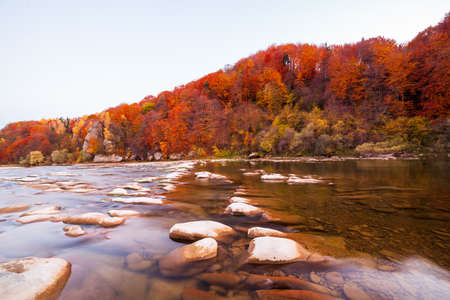 View of the waterfall in autumn. Waterfall in autumn colors. Mountain river in the autumn landscape. Ukraine, river Stryj.の写真素材