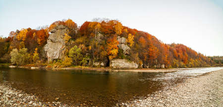 View of the waterfall in autumn. Waterfall in autumn colors. Mountain river in the autumn landscape. Ukraine, river Stryj.の写真素材