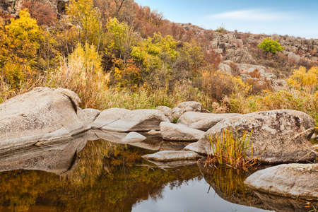 A small wonderful lake along a picturesque river flowing through a beautiful canyon. Huge hatches are in the water. Ukraine.の写真素材