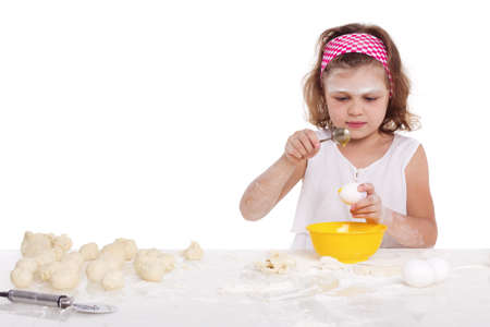 cooking and people concept - girl smiling chef with kitchen utensils, isolated on a white background.の写真素材