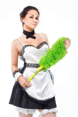 Young beautiful happy maid in apron isolated on white.の写真素材