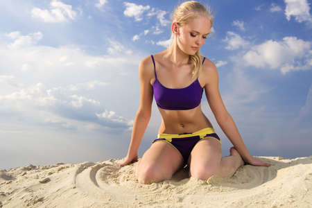 Young woman playing the sand.の写真素材