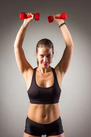 Fitness woman working out on the floor isolated on a white backgroundの写真素材