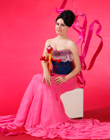 Fashion Model in Red Beauty Dress, Sexy Woman posing evening Gown, Flying Silk Tail over gray backgroundの写真素材