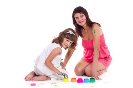 beautiful mommy and her kid paintig a picture for kindergardern. hobby, education, development , child developing painting skills. close up photoの写真素材