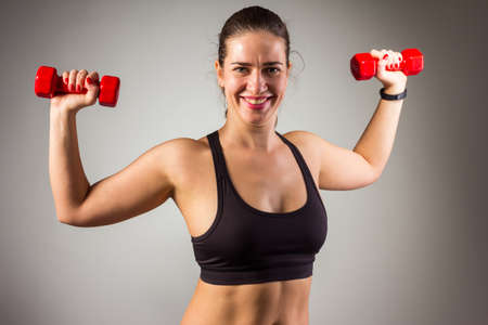 Fitness woman working out on the floor isolated on a white backgroundの写真素材