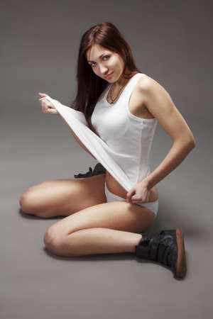 Petite young brunette nude on grayの写真素材