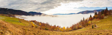 Carpathians, Ukraine.Frozen grass covered with white frost against the backdrop of a beautiful blue sky and fluffy white fogの写真素材