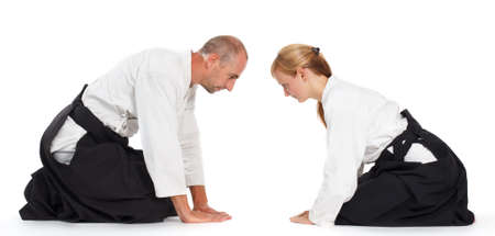 Two people, a man and a woman, practice aikido on the mat. Isolated on white background.の写真素材