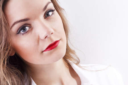 Beautiful brunette with a modern clothing posing on white background.の写真素材