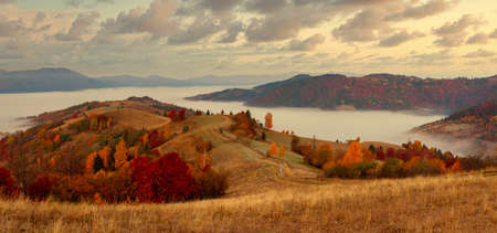Ukraine. A magical autumn sunrise, with mist creeping over valleys, over mountain formations far from civilization. Synevyr pass located in the Carpathian mountains.の写真素材