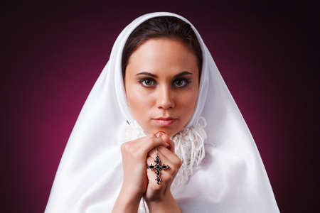 Nice girl dressed as a nun on a black backgroundの写真素材