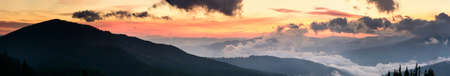 Autumn landscape with fog in the mountains. Fir forest on the hills. Carpathians, Ukraine, Europeの写真素材
