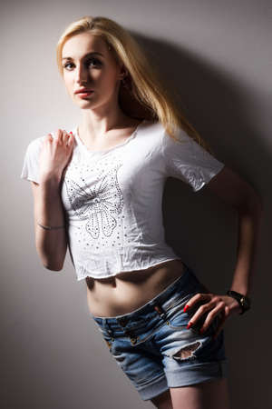 Portrait of a beautiful blonde woman over gray backgroundの写真素材