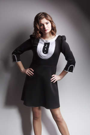 beautiful woman posing in elegant dress on the grey studio background. glasses. Retouched.の写真素材