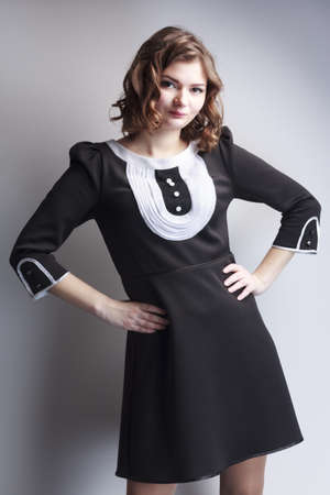 beautiful woman posing in elegant dress on the grey studio background. glasses. Retouched.の写真素材