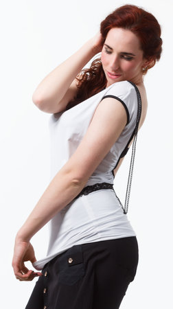 Sexy fashion woman sitting on a chair on a white background, beautiful slender body of a womanの写真素材
