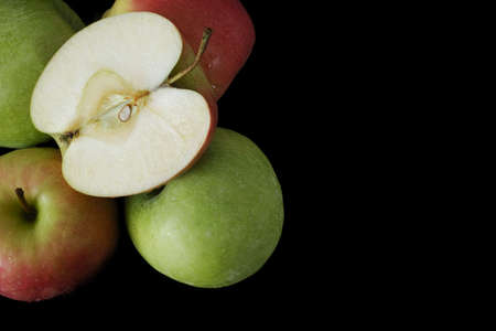 Fresh Granny Smith and Pink lady apples on black backgroundの写真素材