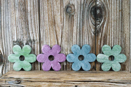 Colorful wooden flowers on wooden background, sweet home concept, copy spaceの写真素材