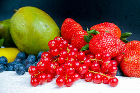 Variety fresh organic red and blue berry, strawberry, mango and  green fruitsの写真素材