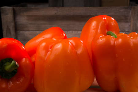 Fresh orange paprika on wooden backgroundの写真素材
