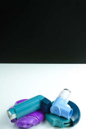 Asthma medication. Set of inhalers and medication for the treatment of bronchial asthma on a black background, copy spaceの写真素材