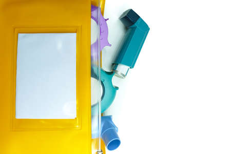 Asthma relief concept, salbutamol inhaler, another medication and yellow medical plastic bag, copy...