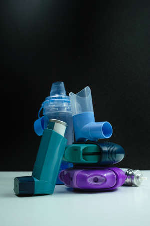 Asthma medication. Set of inhalers and medication for the treatment of bronchial asthma on a black background.の写真素材