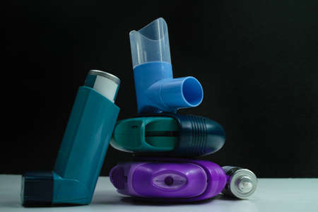 Asthma medication. Set of inhalers and medication for the treatment of bronchial asthma on a black background.の写真素材