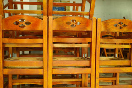 Heap of wooden chairs in closed cafe, out of season in Greeceの写真素材