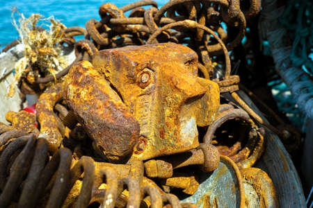 Old iron rusty fisherman's tools for fishing in small French harborの写真素材