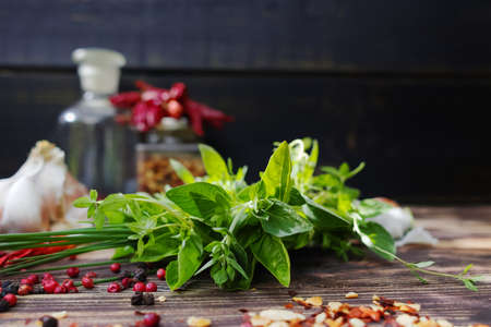 Fresh  italian herbs, garlic, dried red hot chili peppers on old wooden backgroundの写真素材