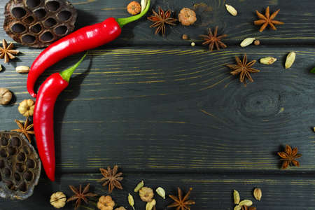Colorful red hot chili peppers on black wooden table topの写真素材