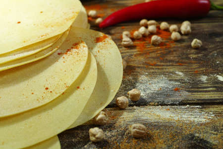 Colorful Indian food - papadum, chickpea,  gram flour and spices on textured wooden table topの写真素材
