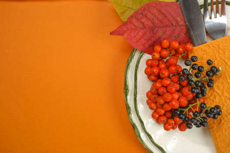 Autumn restaurant menu free text copy space and table setting on orange backgroundの写真素材