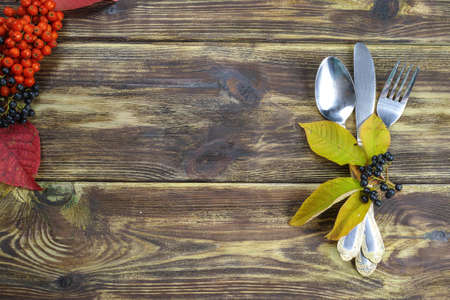 Autumn restaurant menu free text copy space with forest berries and cutlery on wooden backgroundの写真素材